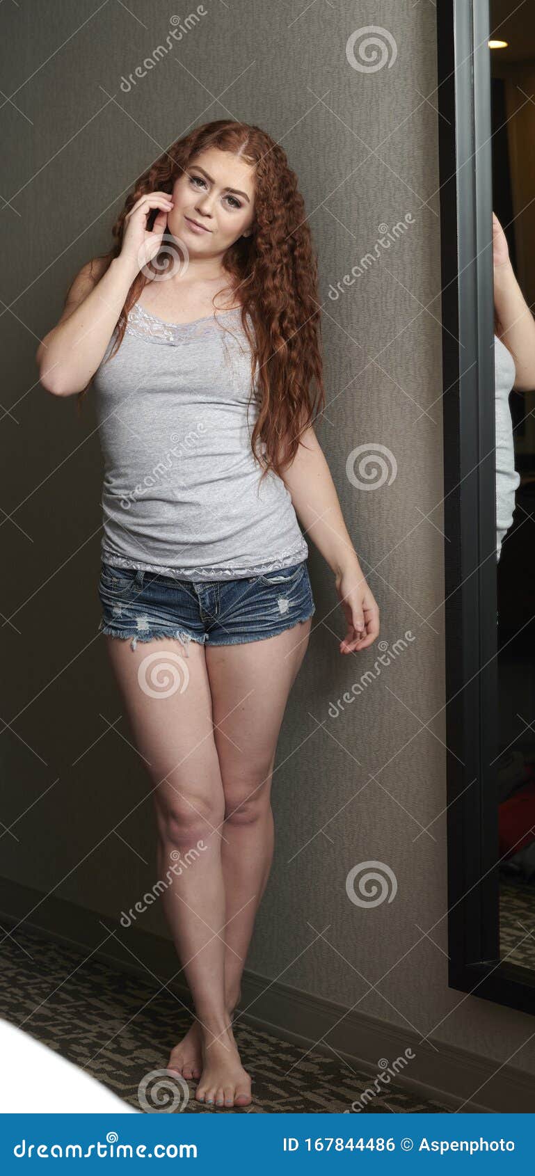 Premium Photo | Fashionable brunette beautiful woman posing in studio  wearing short jeans.