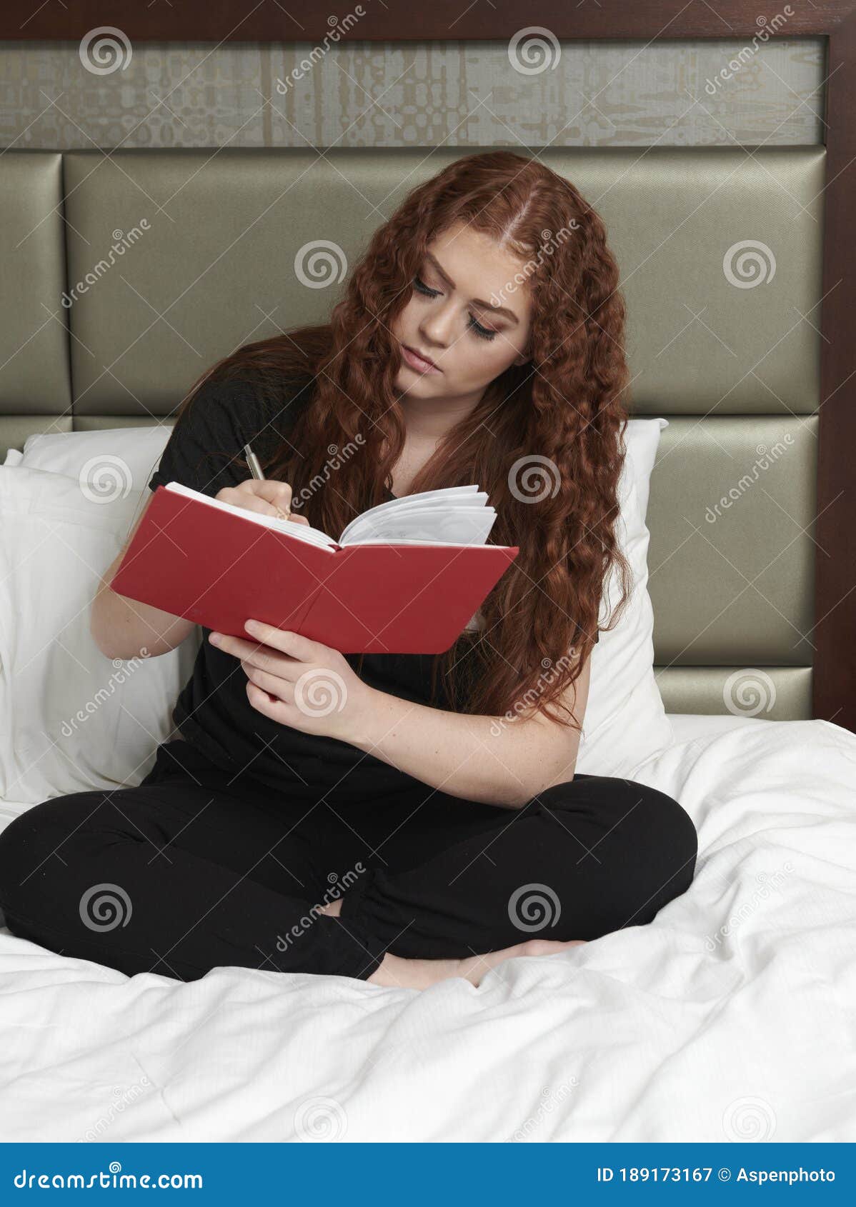 Young Redhead Woman In Bedroom Wearing Black Sweat Pants And T Shirt