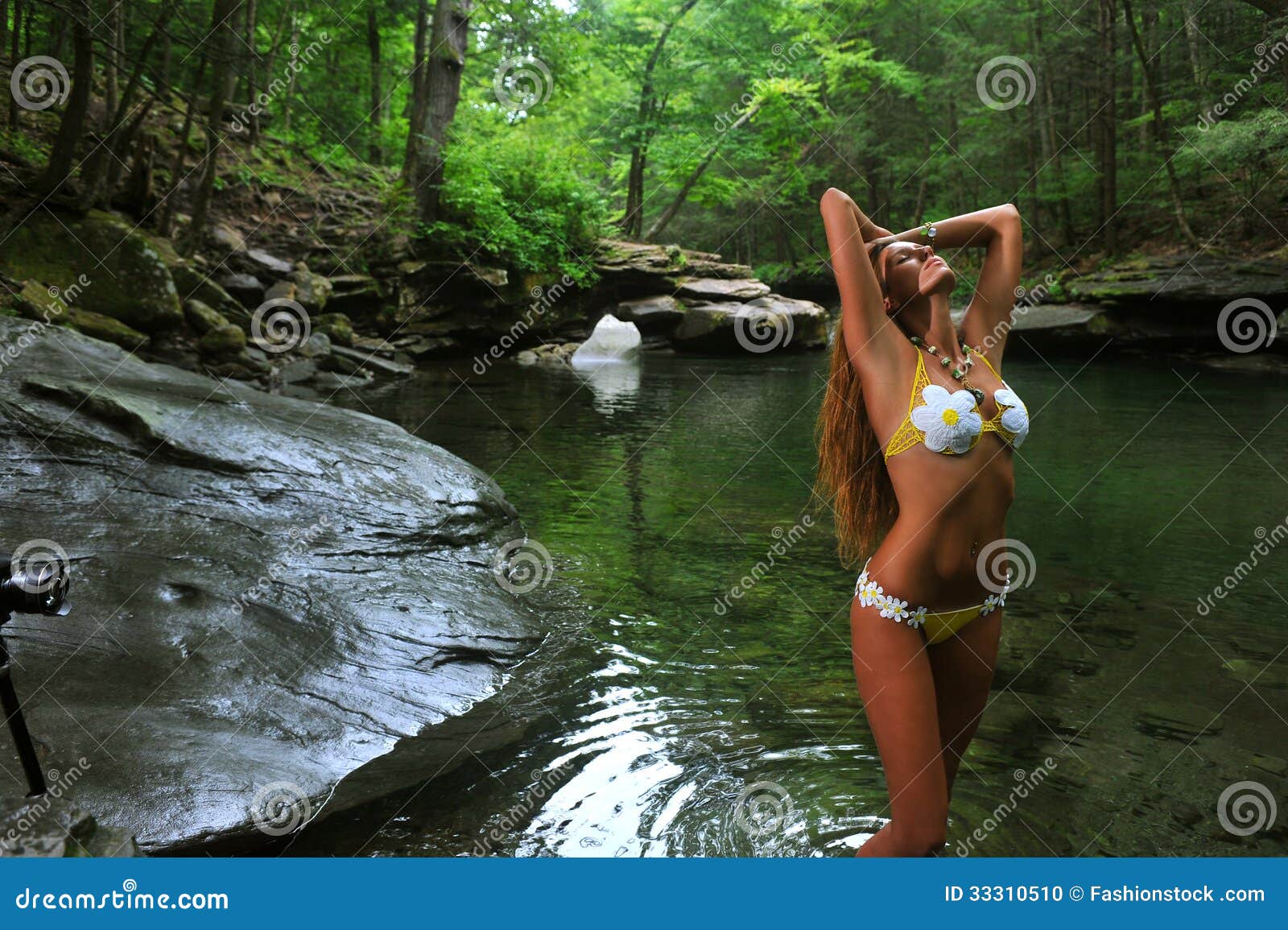 Young Girl In Bikini Doing Stretching Exercises Beside A River At Sunset  Stock Photo, Picture and Royalty Free Image. Image 22017515.