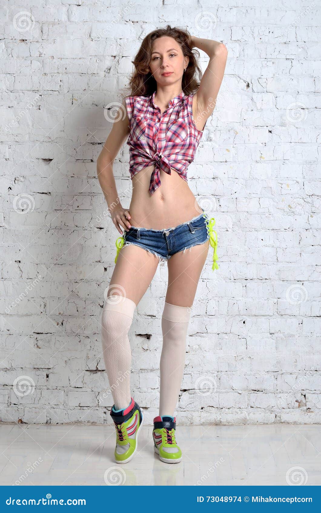 Young Woman in Short Shorts and Sneakers, a Photo in Full G Stock Photo -  Image of model, legs: 73048974