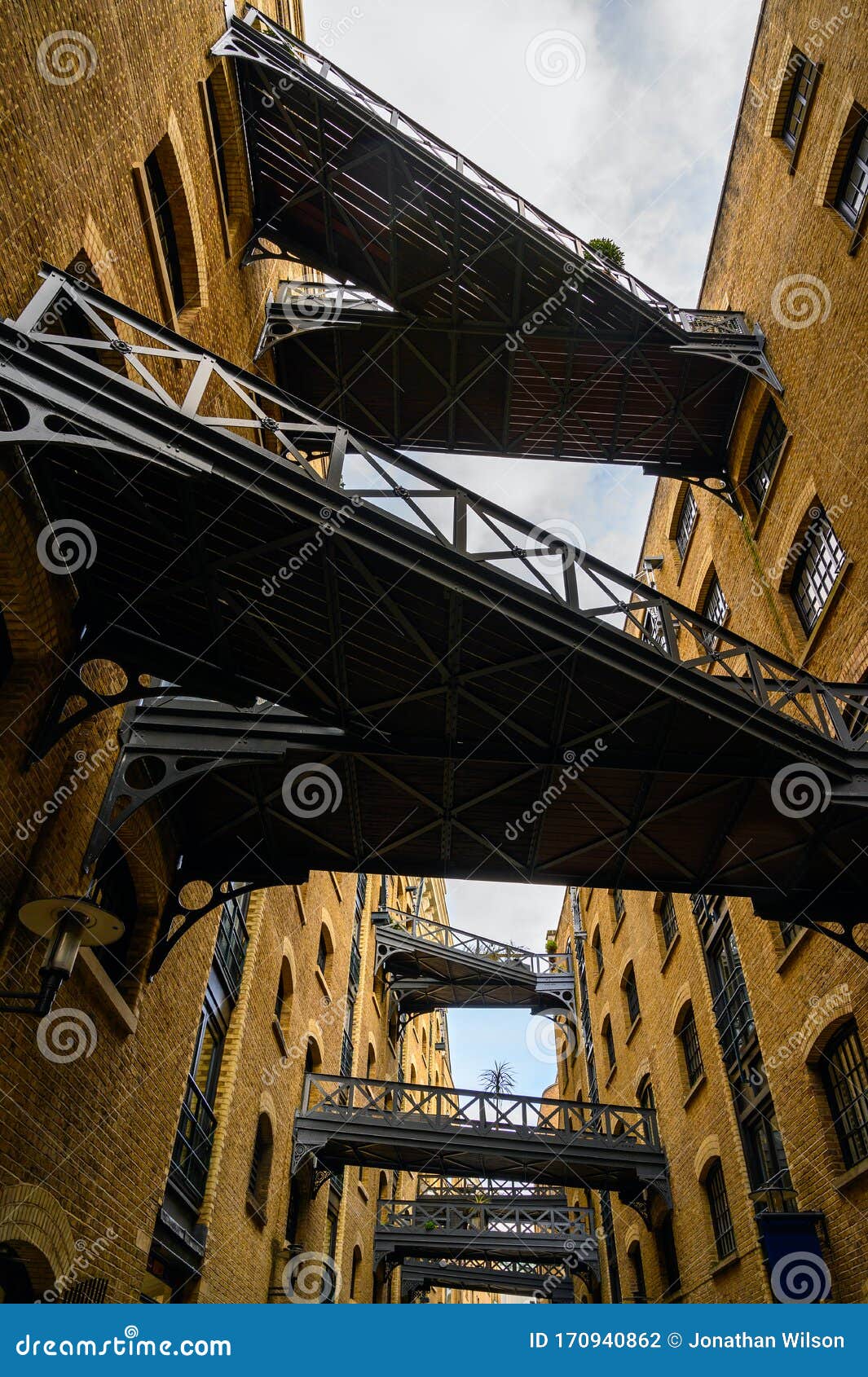 shad thames in london, uk. historic shad thames is an old cobbled street known for it`s restored overhead bridges and walkways