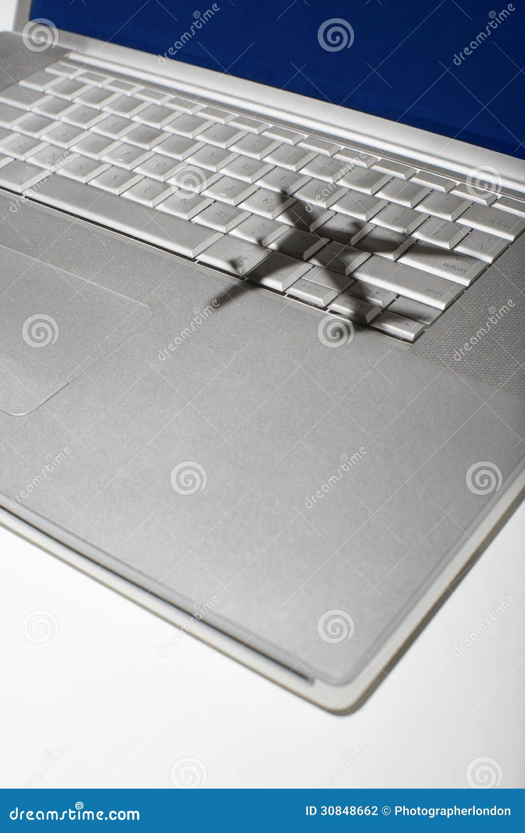 shadow of jumbo jet over apple macintosh keyboard