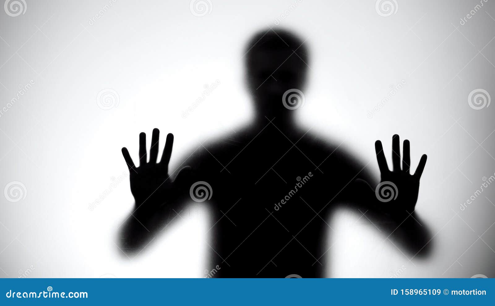 shadow of trapped man touching glass wall, room escape concept, close-up