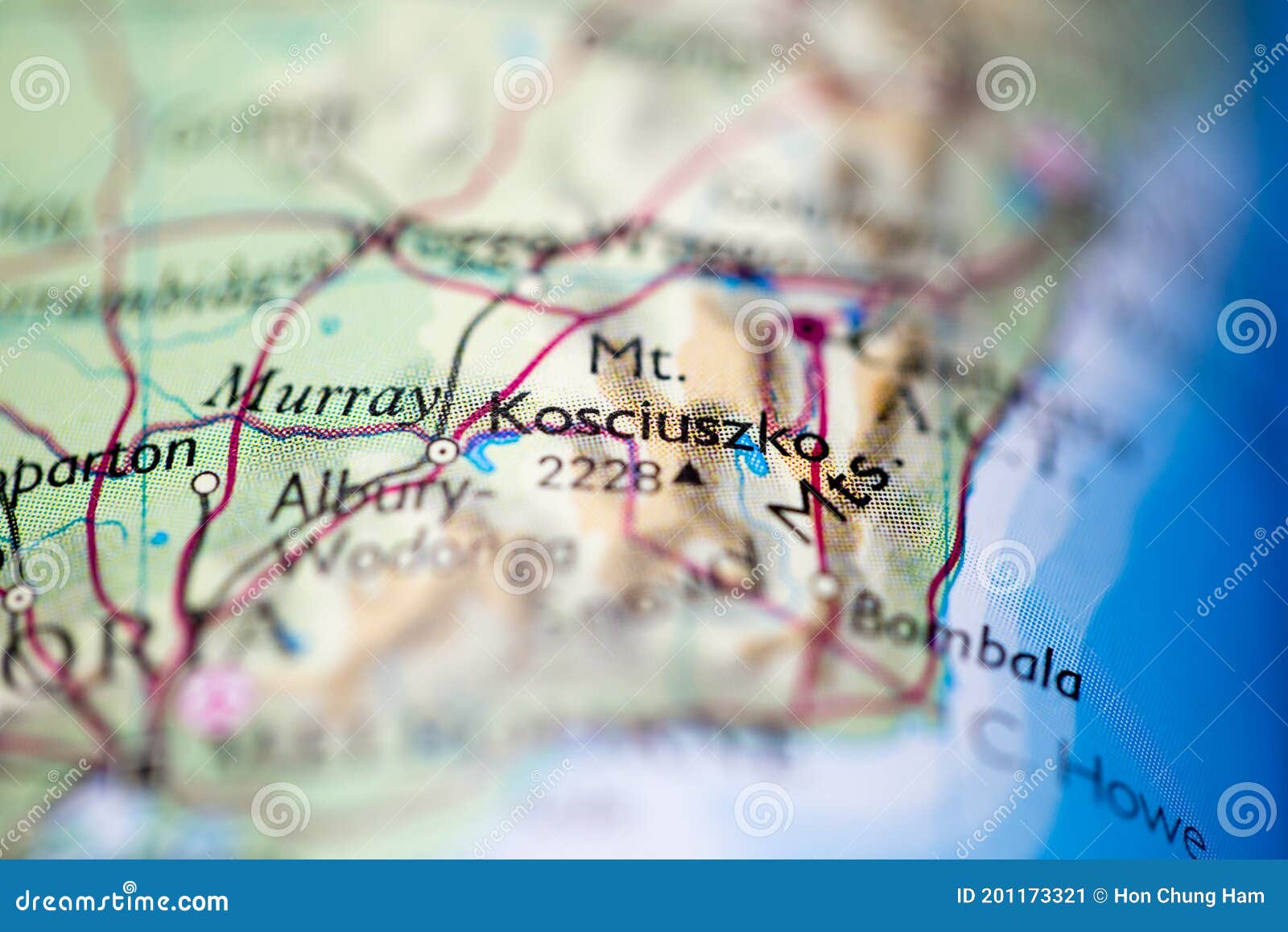 shallow depth of field focus on geographical map location of mount kosciuszko in australia oceania continent on atlas