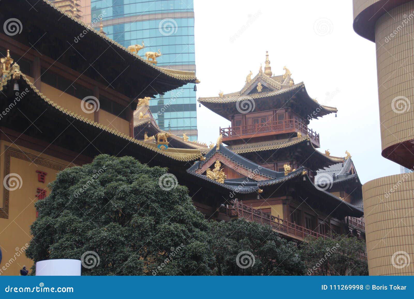 shanghai, china - : close up golden roof of beautiful temple building located inside jing`an temple district.