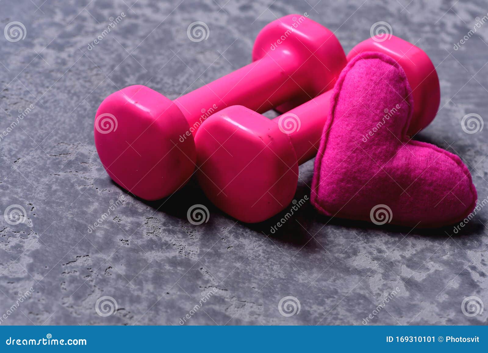 shaping and fitness equipment. dumbbells made of pink plastic