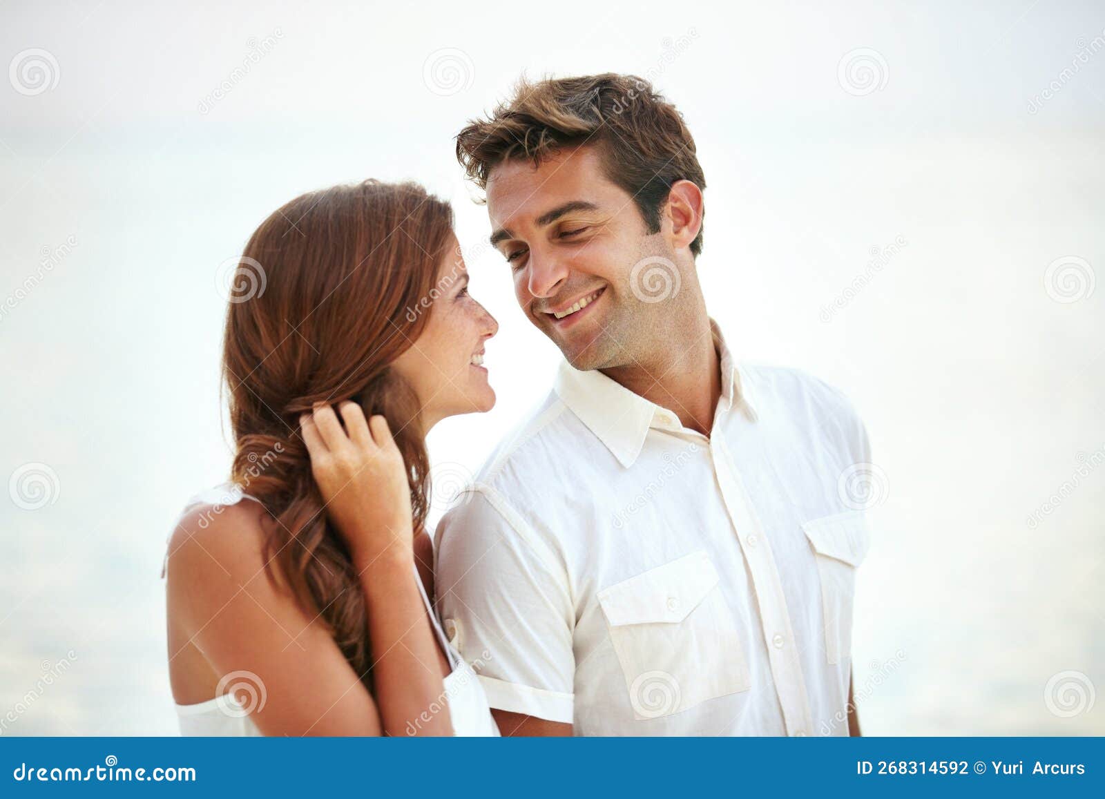 Sharing A Tender Moment A Loving Young Couple Gaze Into One Anothers Eyes During A Romantic