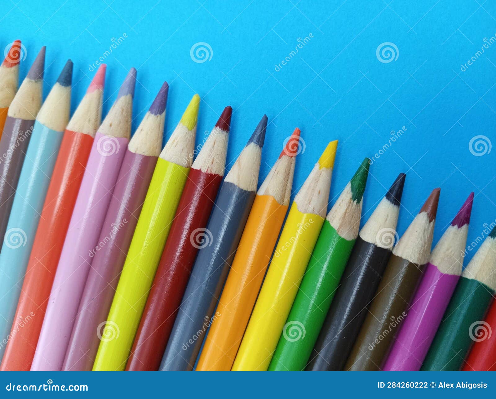 Close-up detail of sharp colourful pencil crayons laid side by side on  white paper background by lines drawn in each colour - Yorkshire, England,  UK Stock Photo - Alamy