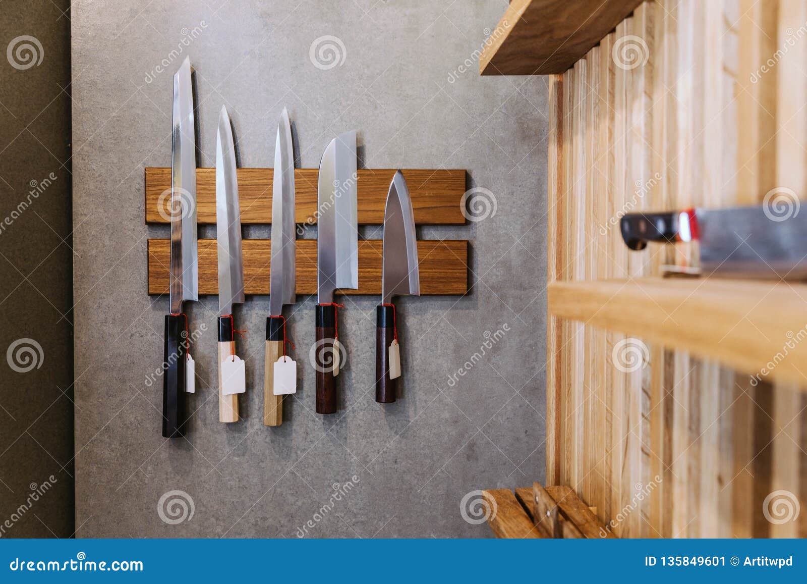 sharp japanese kitchen knives with empty price tag stick on magnet cover with wood on concrete wall