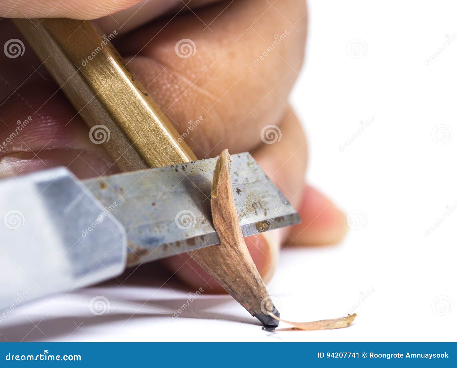 Sharpened Wooden Pencil by Cutter Knife Closeup on White Backg Stock