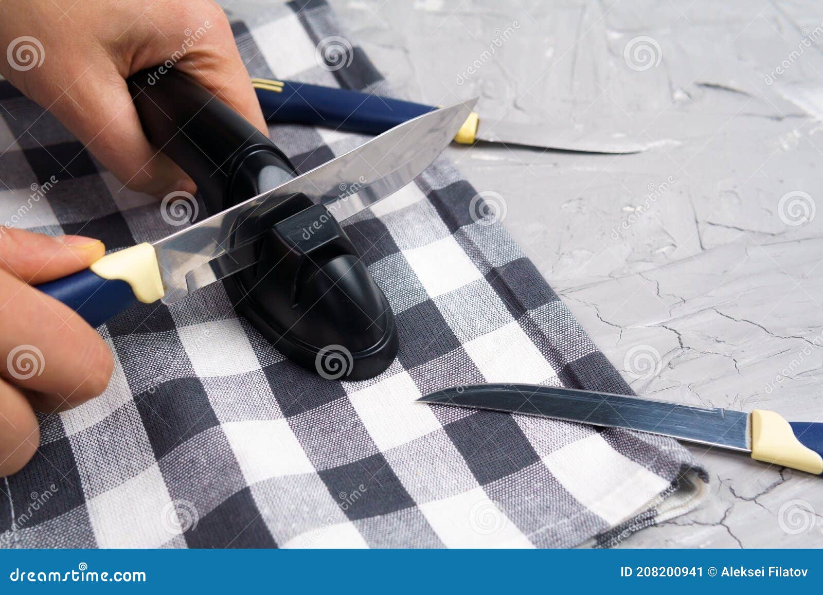 Sharpening a Knife. Closeup of a Man Using a Sharpener To Sharpen a