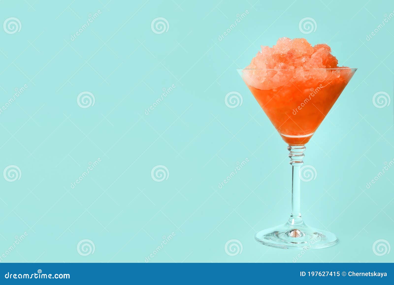 Shaving Ice in Martini Glass on Blue Background, Space for Text Stock