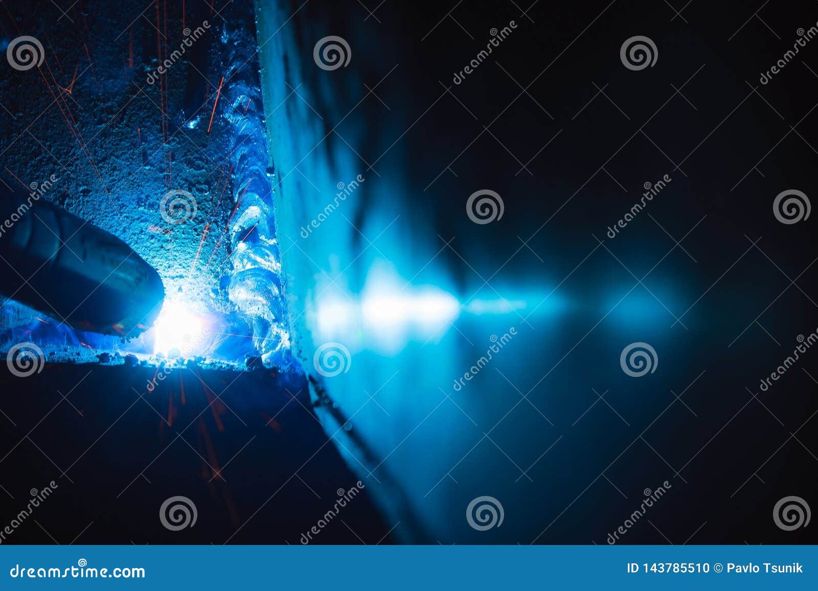 A Sheaf of Sparks Caused by a Welding Arc. Semiautomatic Welding Work