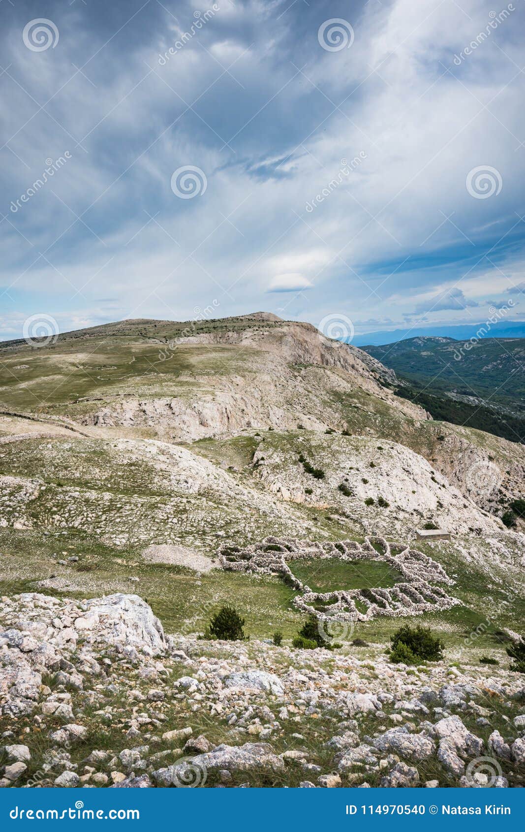 a view towards mrgar, a sheepfold in a  of flower, in the karst landscape above baska, island of krk, croatia