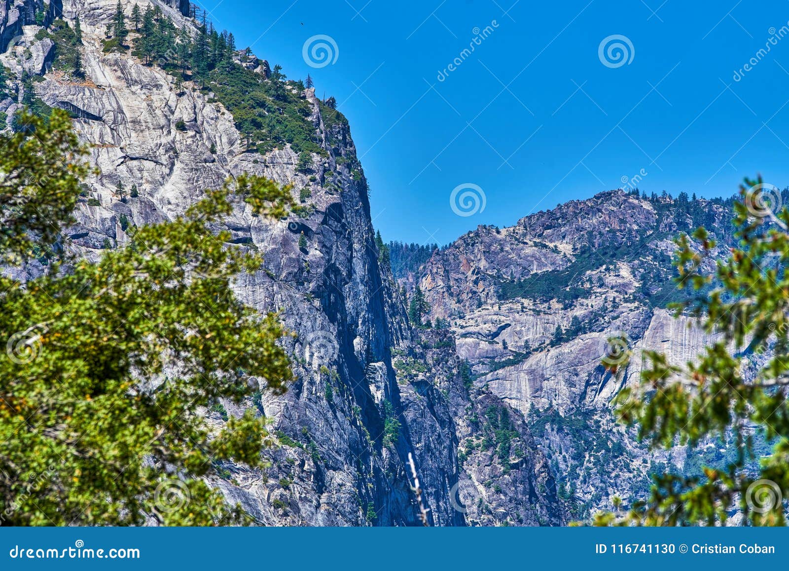 sheer rock granite face in yosemite as seen from vernal falls area
