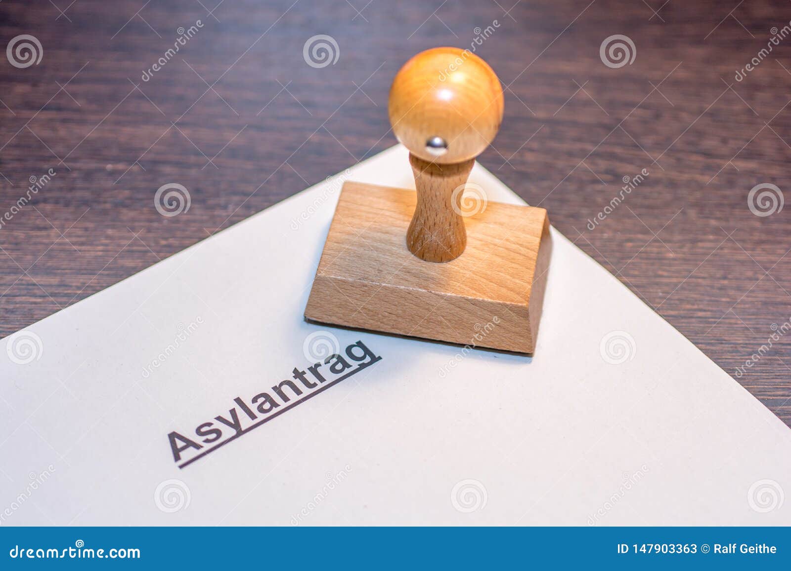 application for asylum with wooden stamp with the german word for asylum application