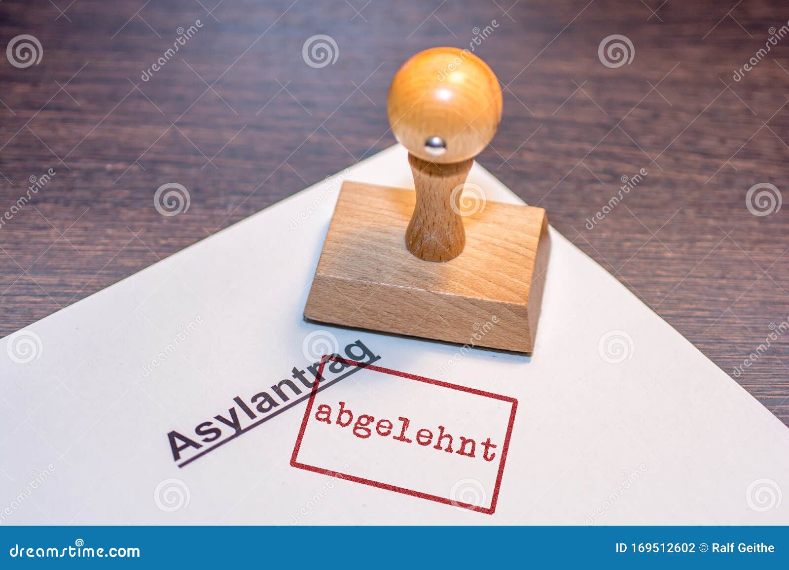 stamp on white paper with the german words `asylum application rejected`