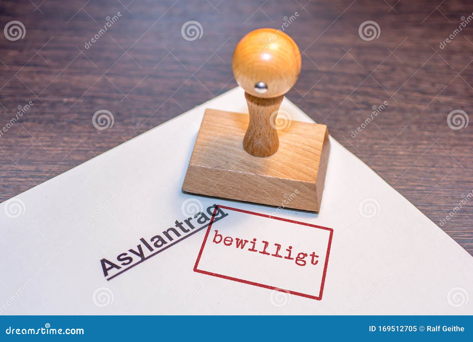 stamp on white paper with the german words `asylum application granted`