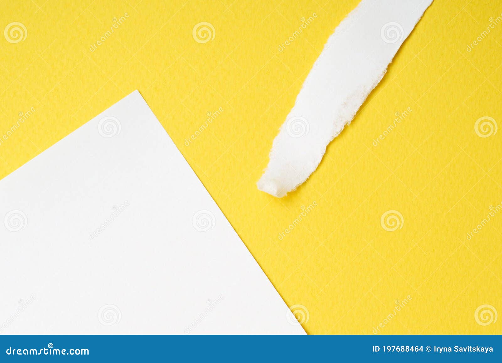 Sheet and Scrap of White Paper on a Yellow Paper Background. Stock
