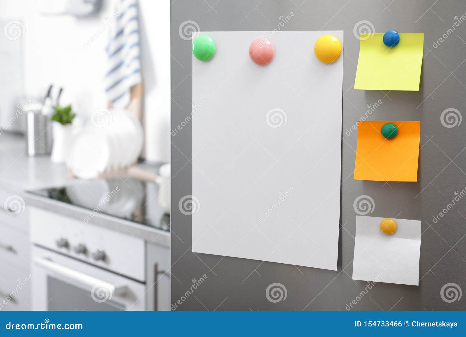 Sheets of Paper with on Refrigerator Door in Kitchen Stock