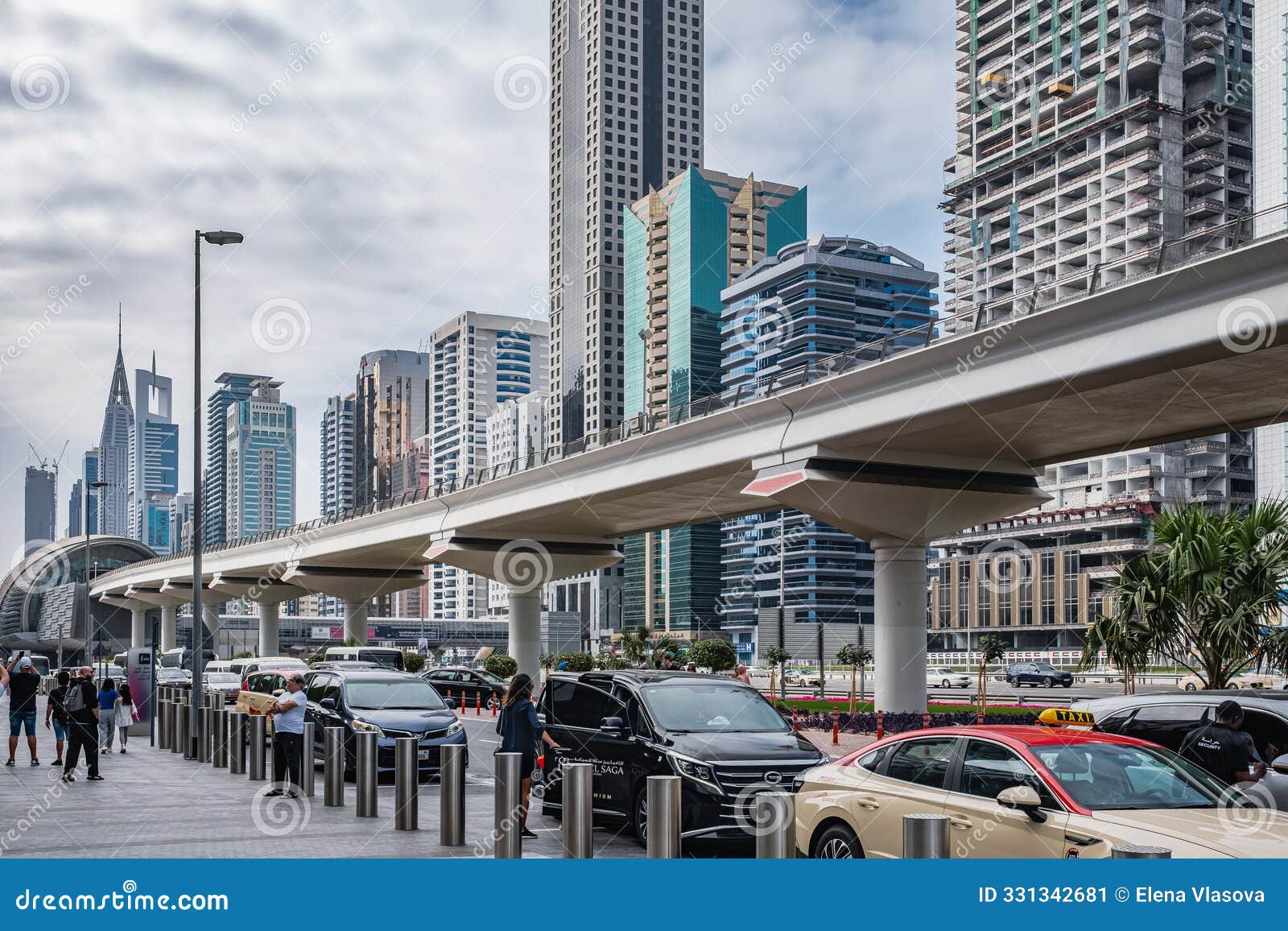 Sheikh Zayed Road Traffic Day with Skyscrapers. Line of Dubai Metro UAE
