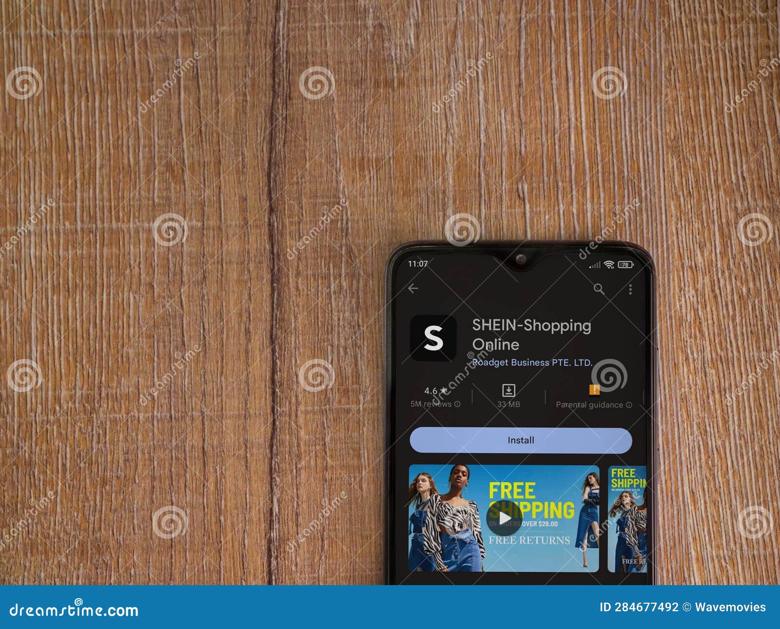 Shein App Play Store Page on Smartphone on Wooden Background