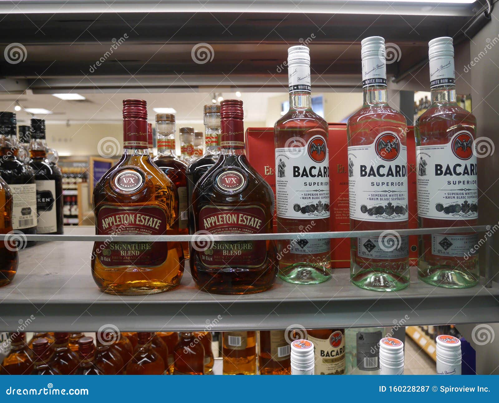 Shelf of bottles of liquor editorial photography. Image of interior