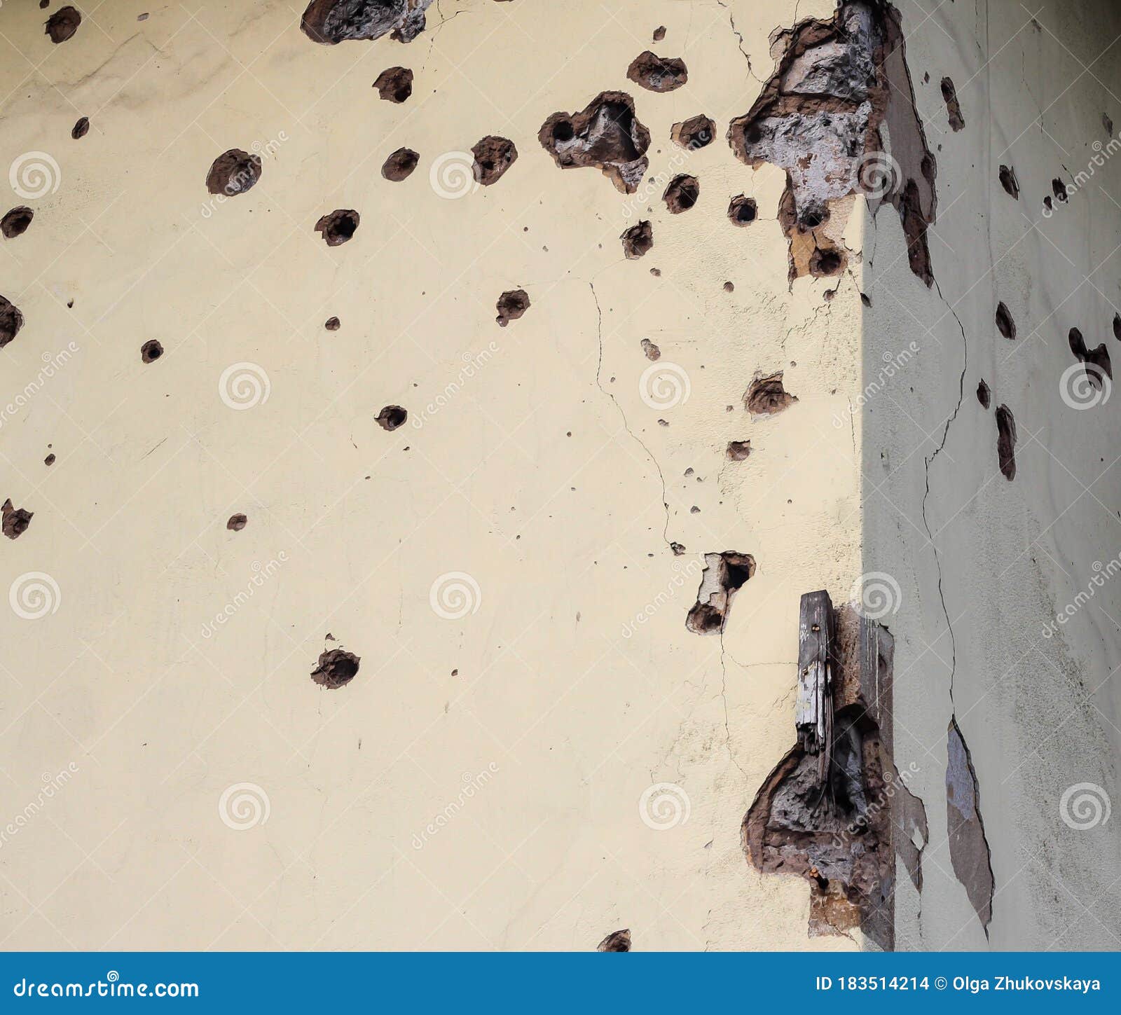 shelled wall of a residential building. consequences of the war in the donbas. housing stock of the dpr. holes from fragments of a