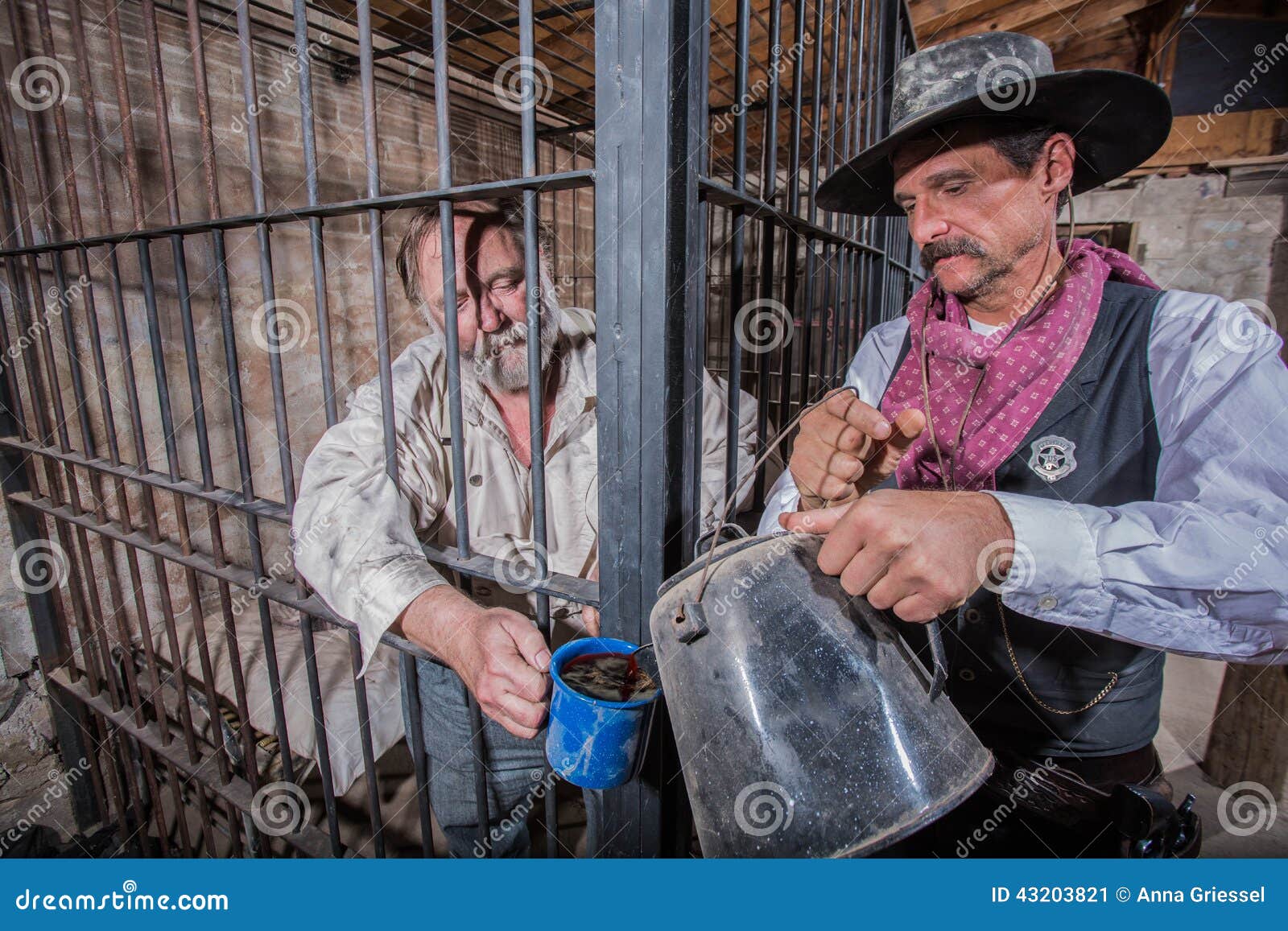 Sheriff Tends to Prisoner. Sheriff Tends to a Prisoner In a Cell