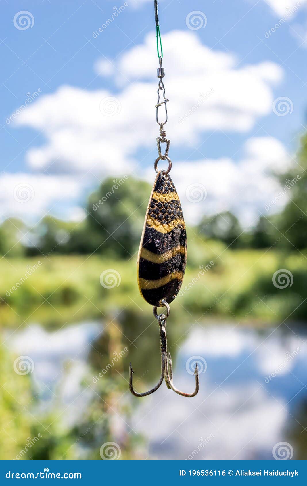 Shine for Fishing Hangs/metal Bait for Fishing on the Background of the  River Stock Photo - Image of fish, colorful: 196536116