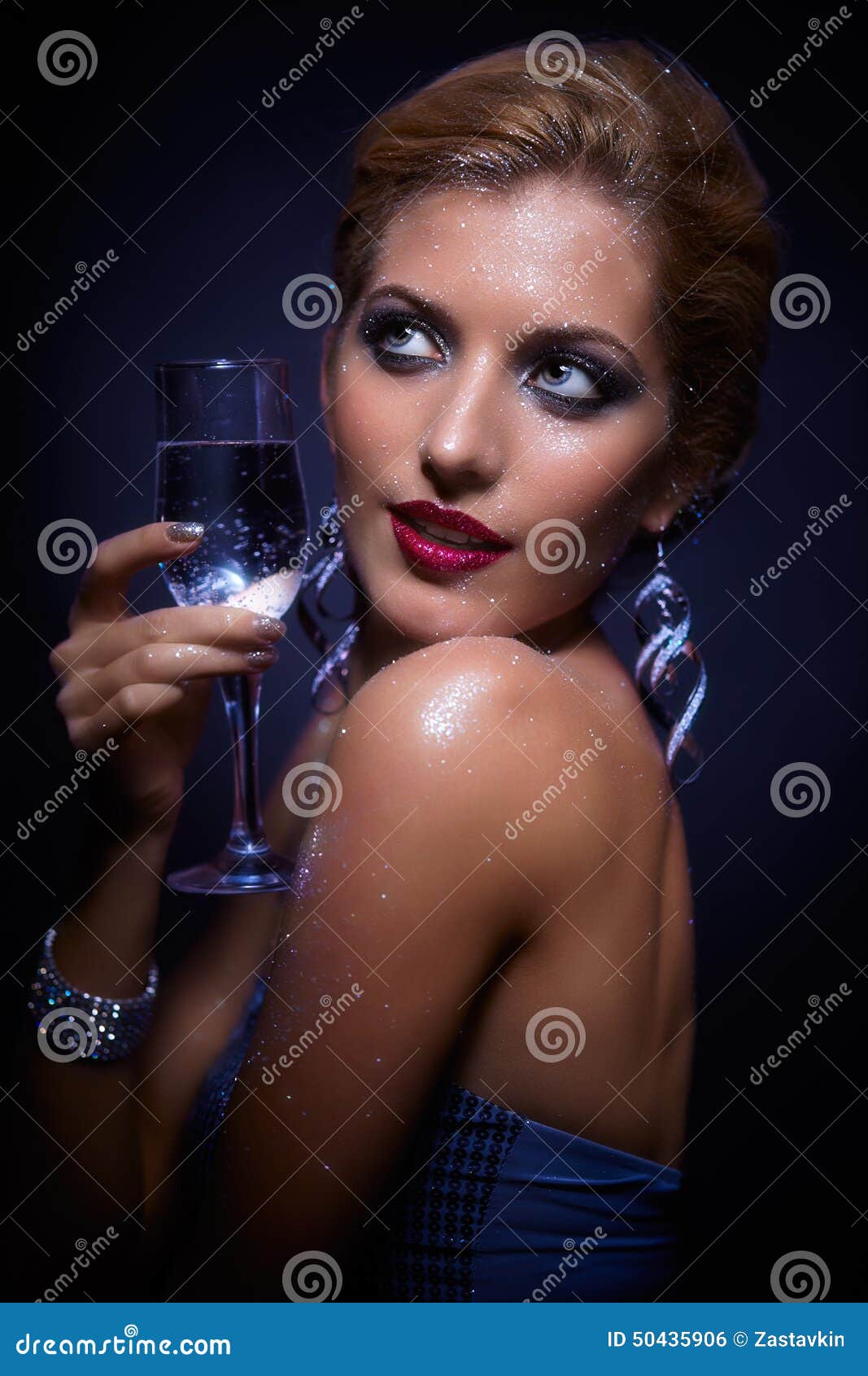 Elegant Woman with Big Boobs in Tight Blue Dress Holding Wineglass