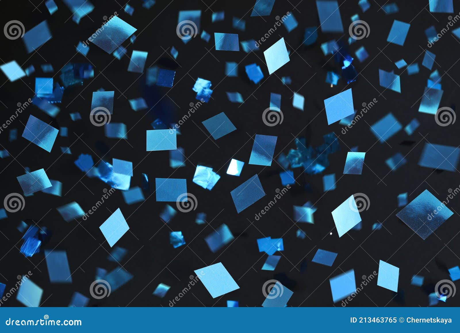 Shiny Blue Confetti Falling Down on Black Background Stock Image