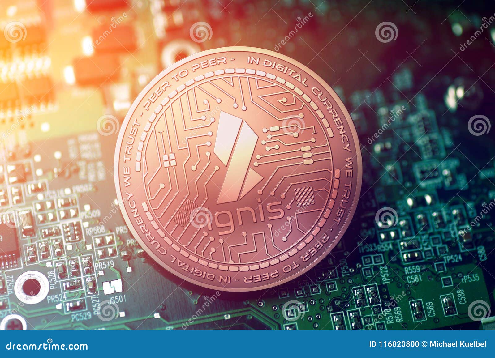 shiny copper ignis cryptocurrency coin on blurry motherboard background