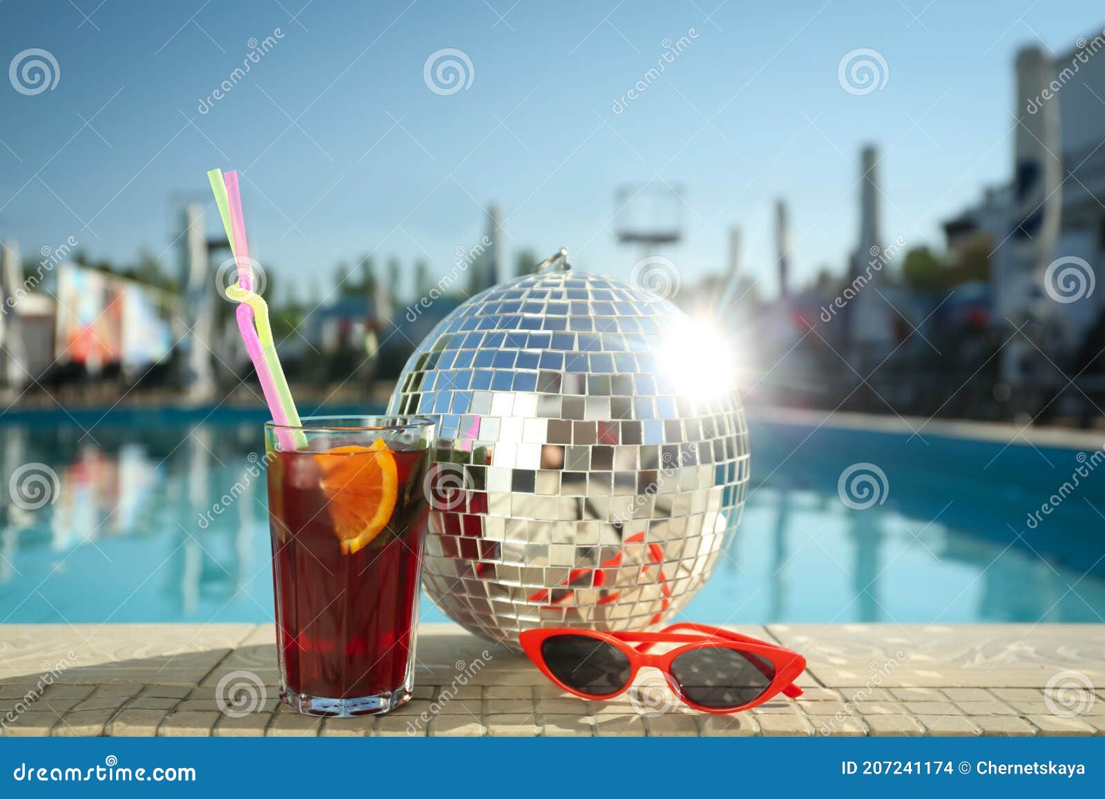 Shiny Disco Ball Refreshing Cocktail And Sunglasses On Edge Of Swimming Pool Party Items Stock