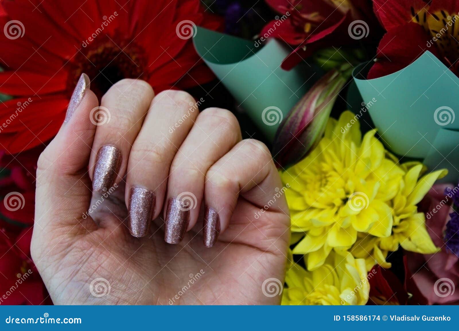 shiny sparkling nude nails on the background of multi-colored colorful flow...