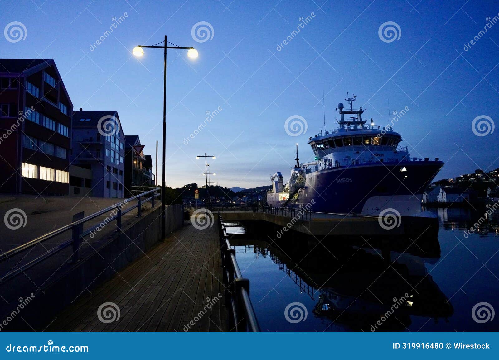 ship docked at the port city of kristiansund, norway.