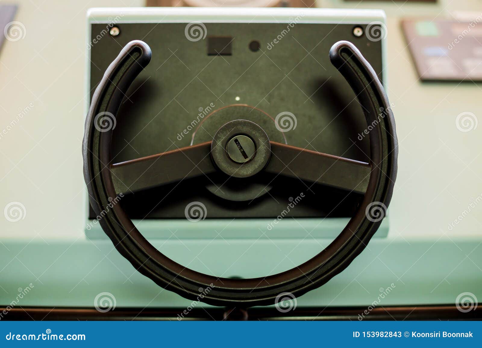 Ship Steering Wheel on Panel in Control Room Oninternational Cargo Ship