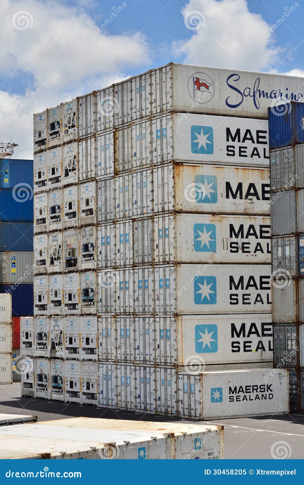 A stack of metal shipping containers in a port.