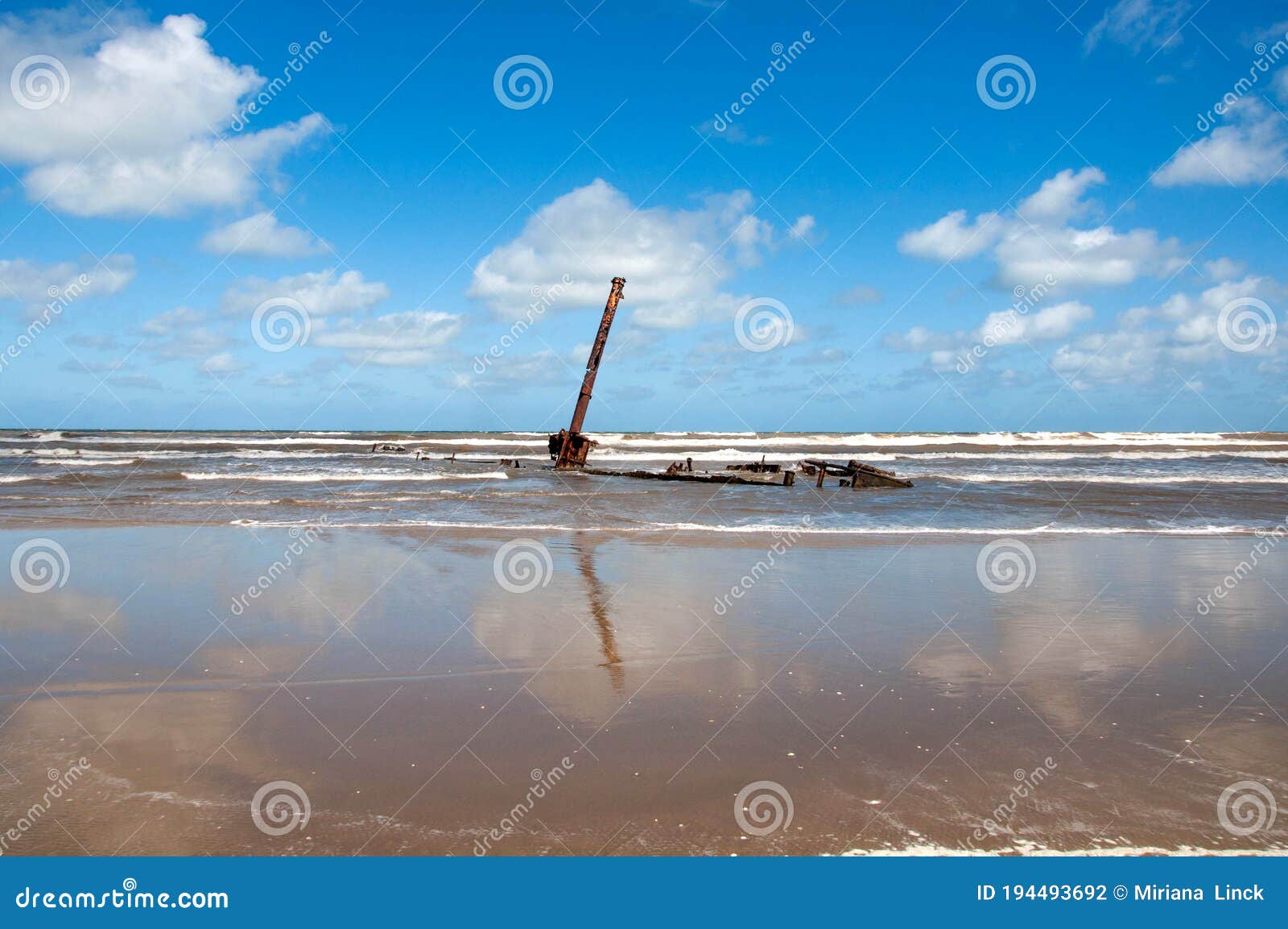 ruined boat stranded on beachside