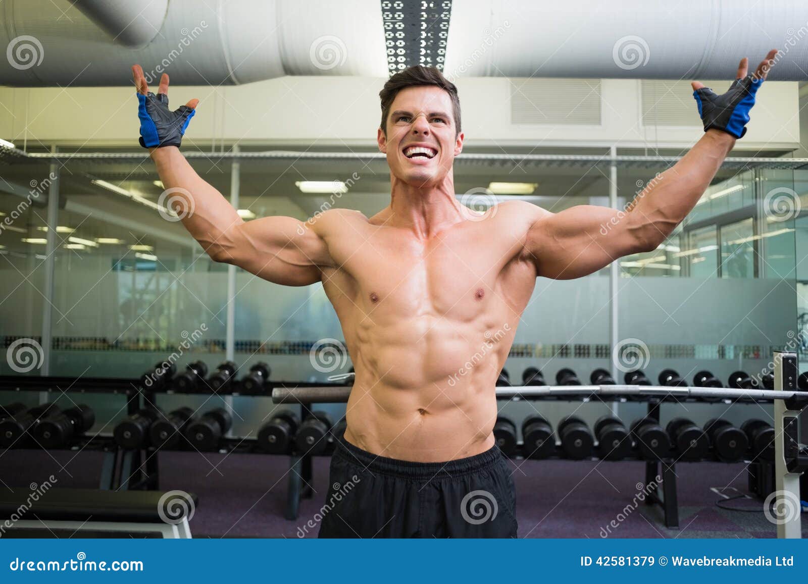 Shirtless Bodybuilder with Arms Raised in Gym Stock Image Image of