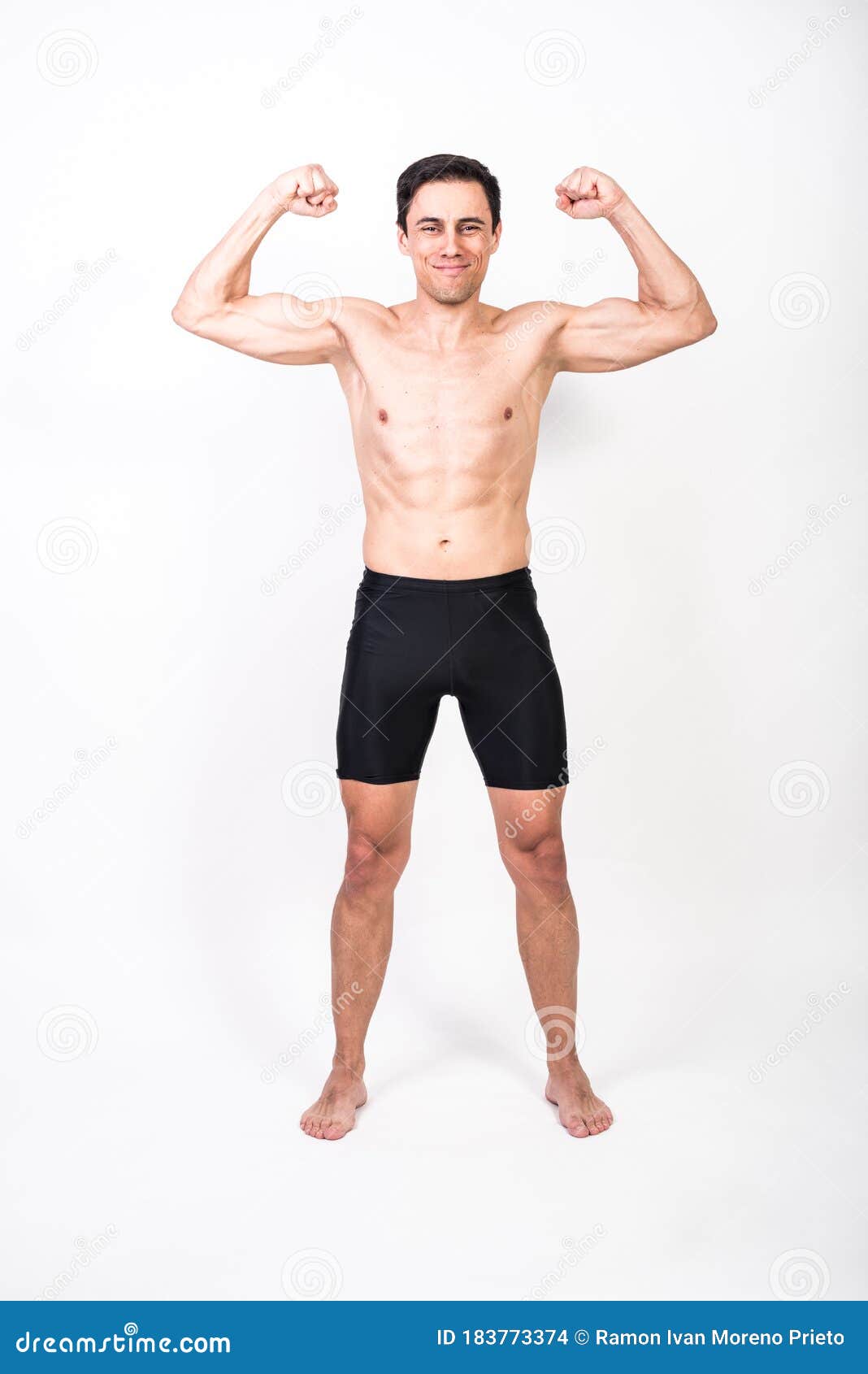 Shirtless Man Standing Taking Out Biceps Looking at Camera Stock Photo ...