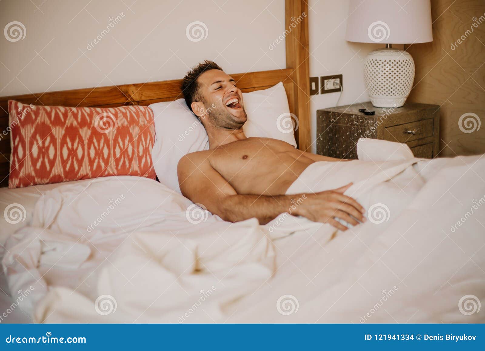 Shirtless Male Model Lying Alone On His Bed In His Bedroomcarefree Guy