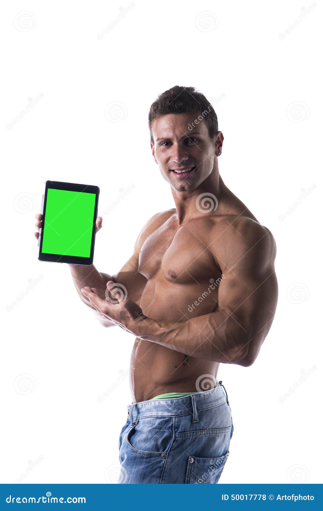 shirtless young male bodybuiler holding ebook reader or tablet pc