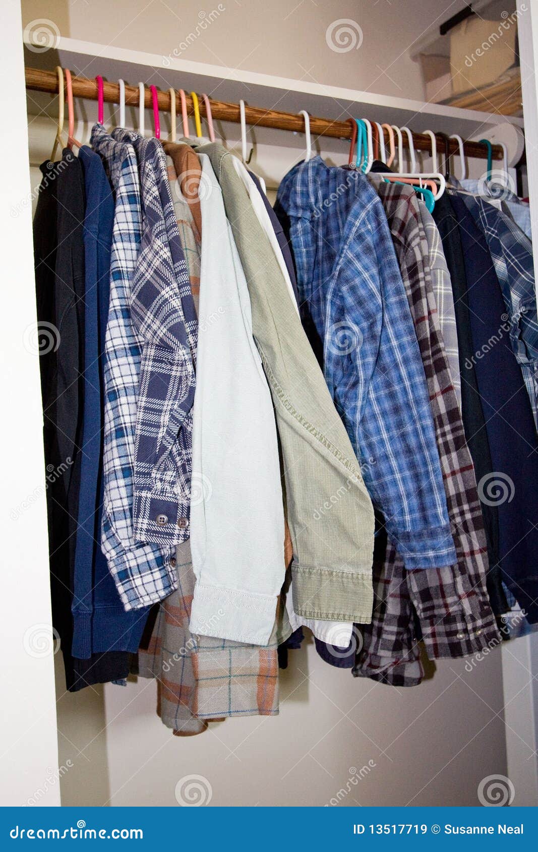 Shirts hanging in a closet stock image. Image of longsleeves 13517719