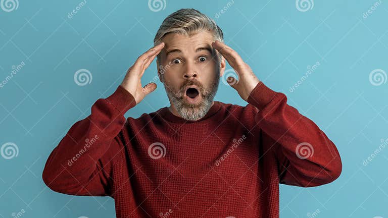 Shocked Appalled Middle Aged Man Gesturing on Blue Background Stock