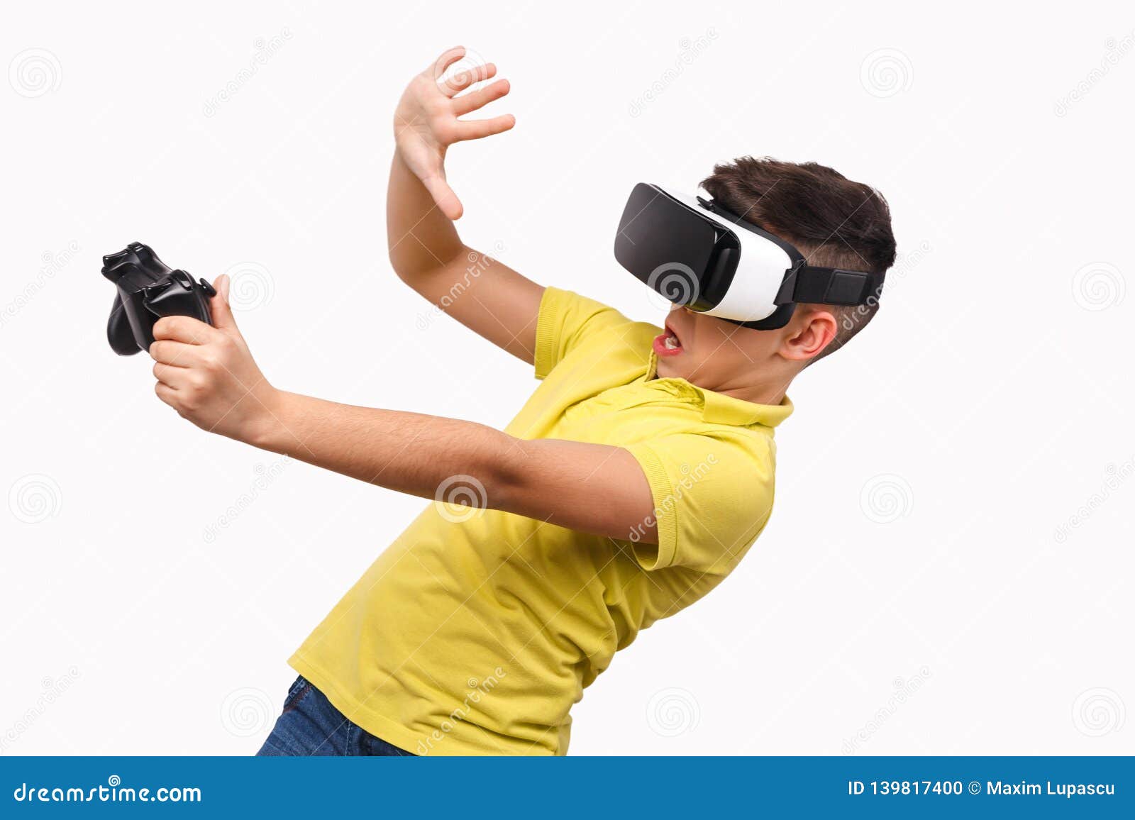 Shocked Boy With Controller Evading Danger In Virtual Reality Stock