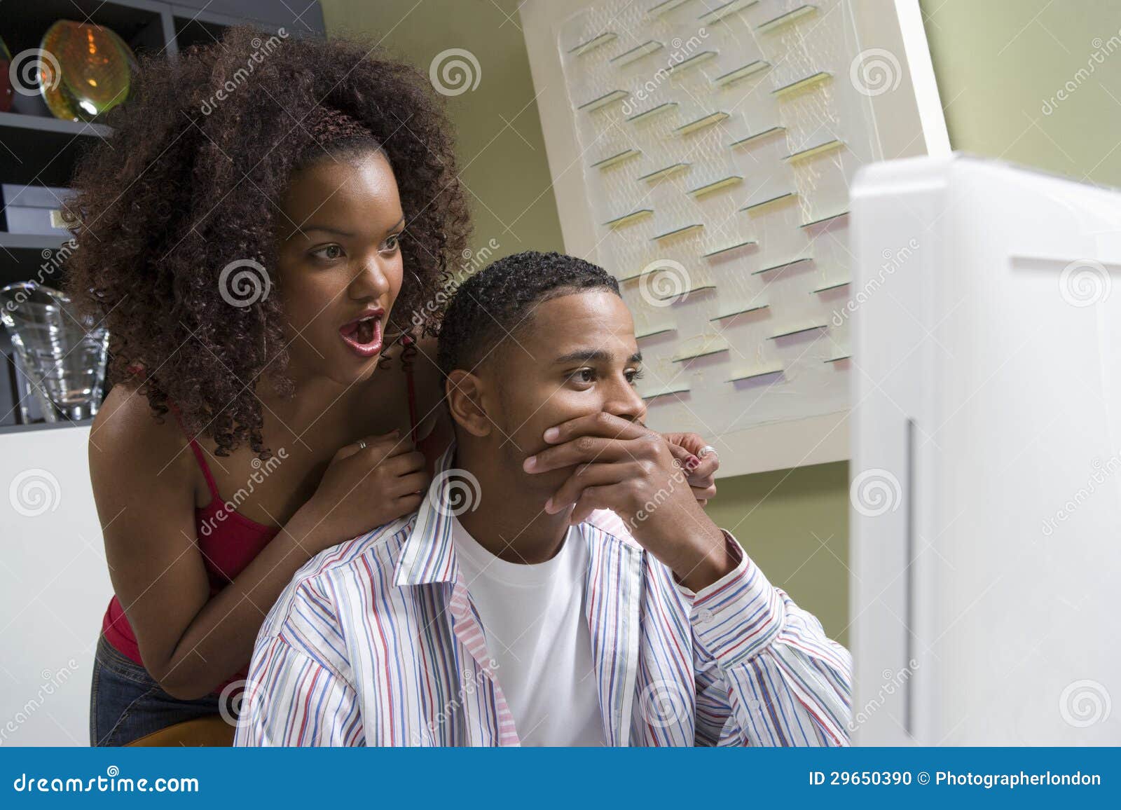 shocked couple looking at desktop pc