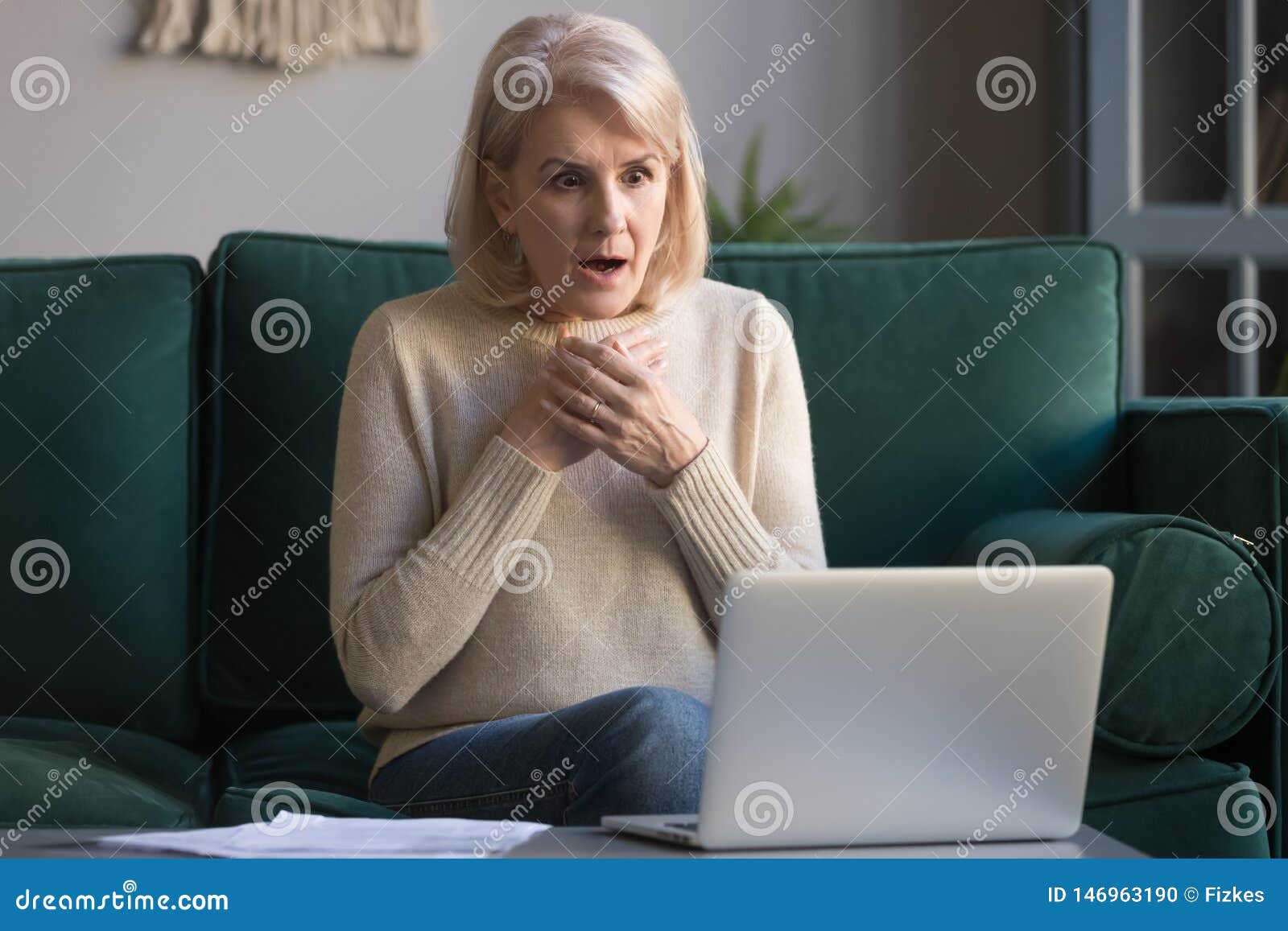 Shocked Grey Haired Mature Woman Reading Unexpected News On Laptop 