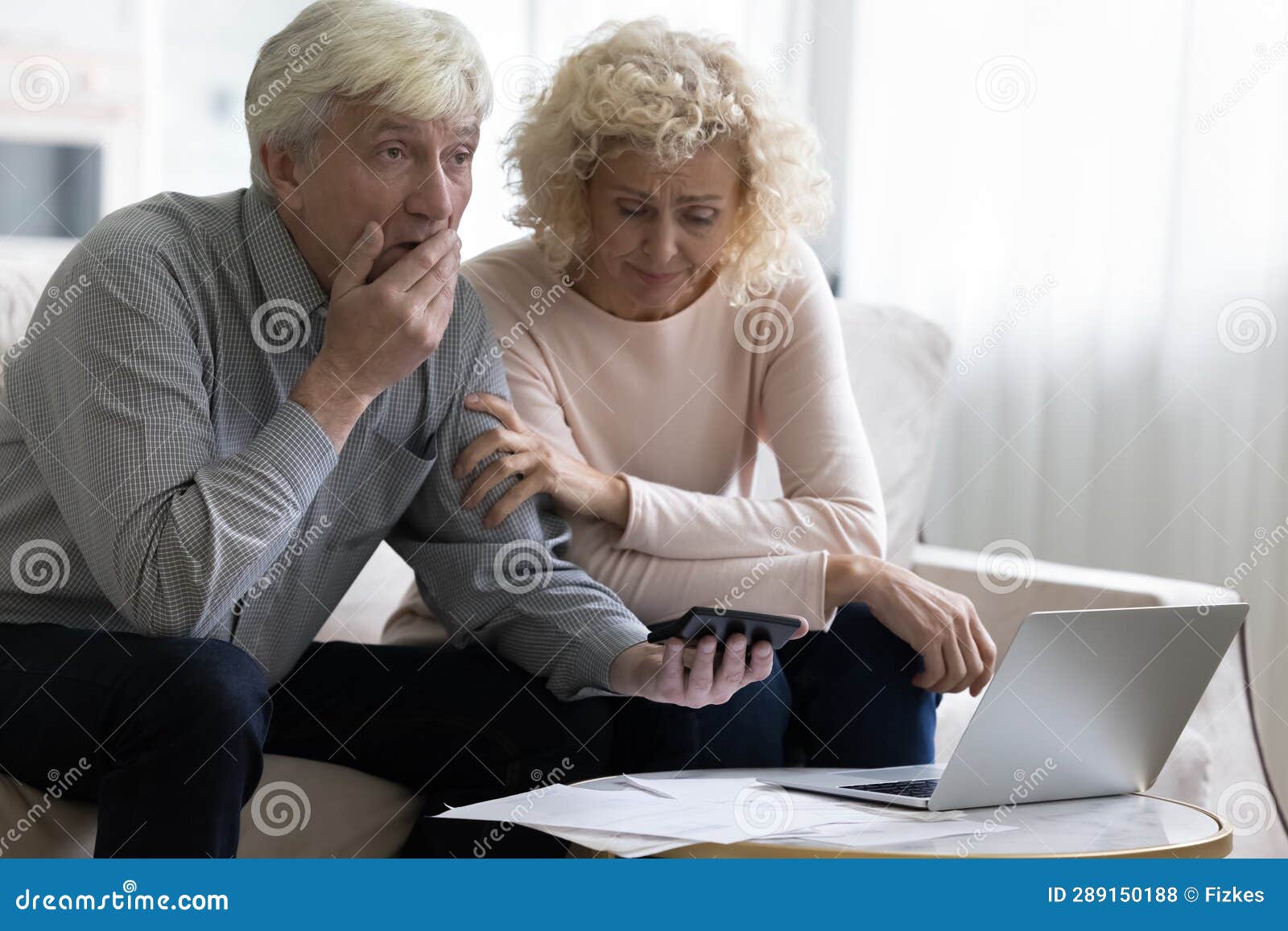 shocked upset retired older couple counting overspent budget