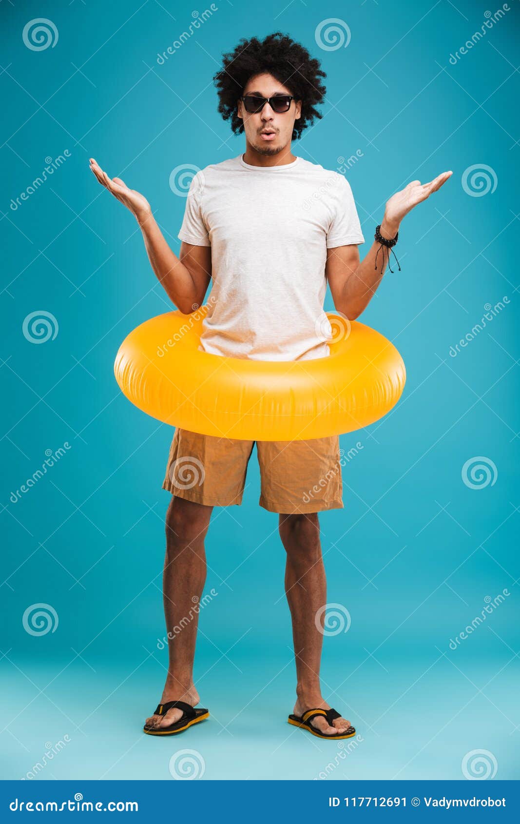Shocked Young African Curly Man Holding Rubber Ring. Stock Image ...